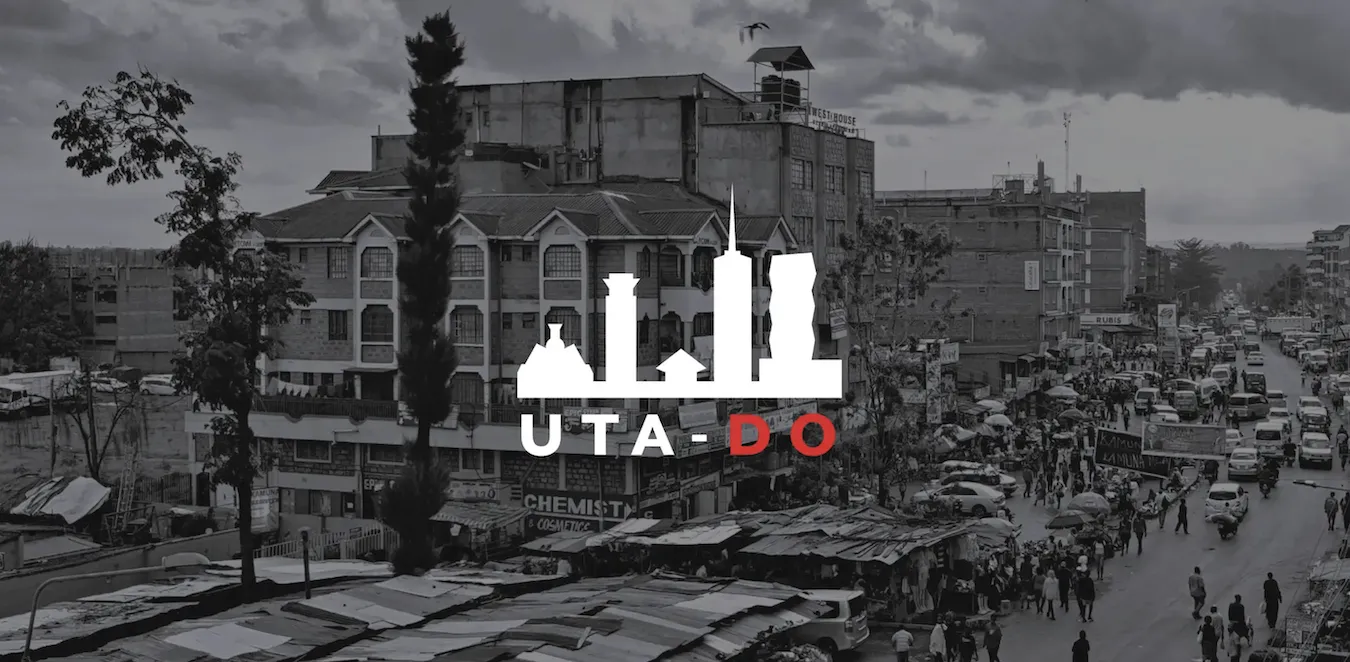 A white city skyline against a black-and-white picture of a city, with the text "UTA-DO."