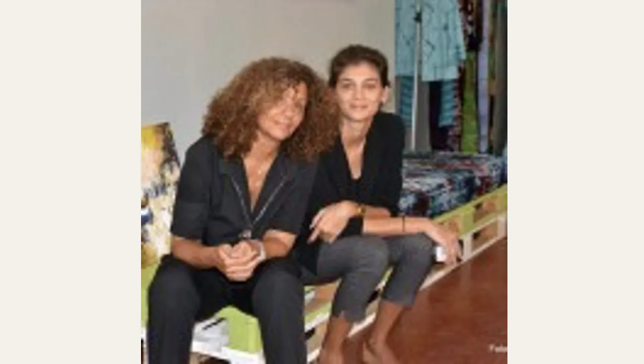 Two women sitting down