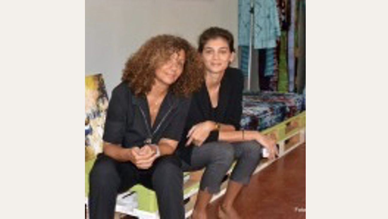 Two women sitting down