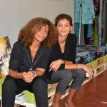 Two women sitting down