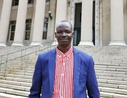James Atem standing in front of Columbia Library